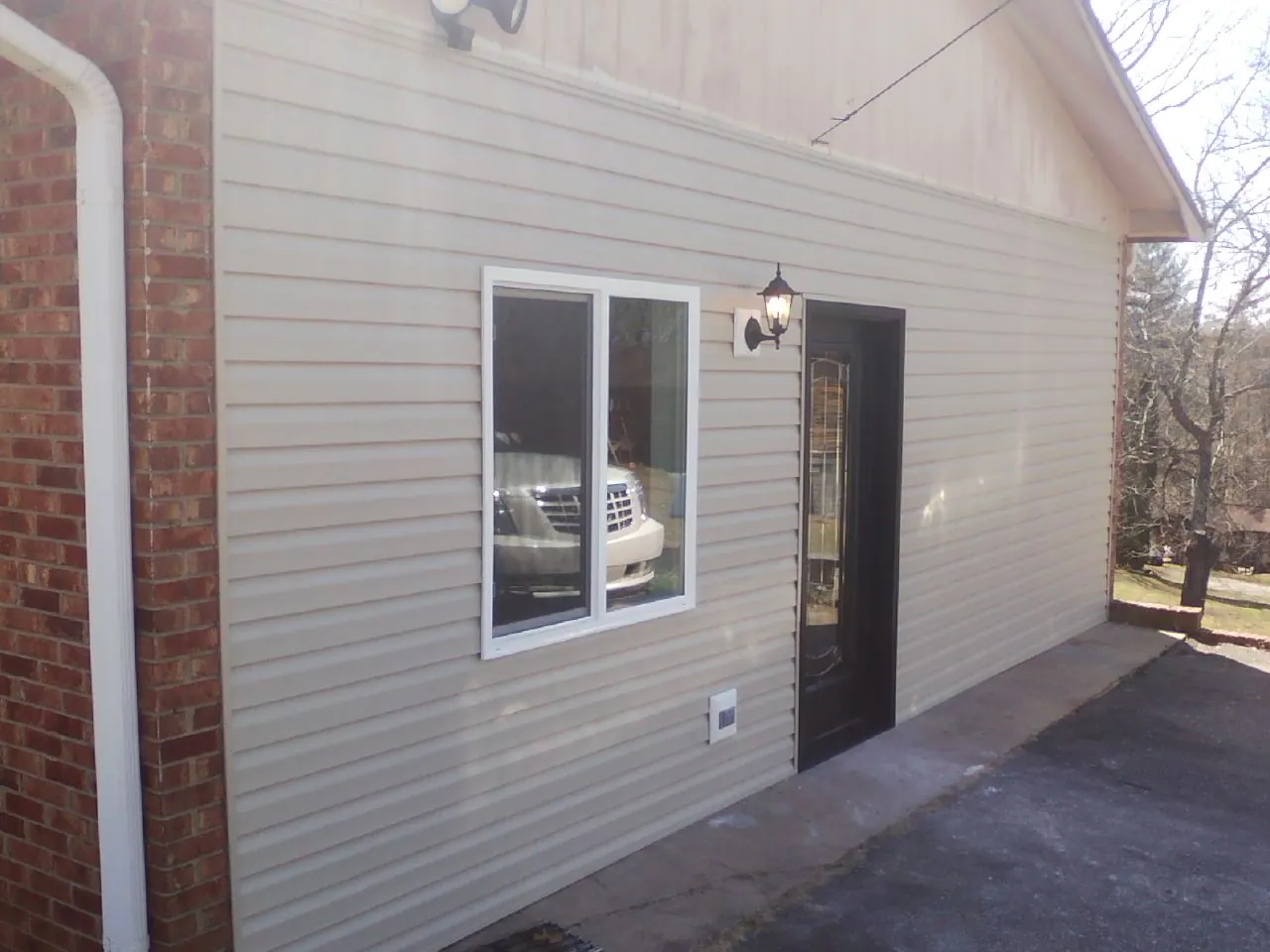 New vinyl siding and entry door on a room addition in Frankfort